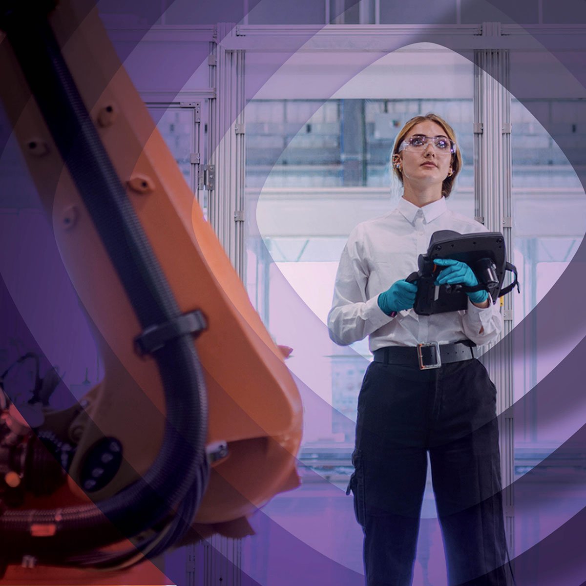 Woman standing by technology with controller in hand